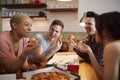 Group Of Gay Friends Meeting At Home And Eating Takeaway Pizza Royalty Free Stock Photo