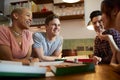 Group Of Gay Friends Meeting At Home And Eating Takeaway Pizza Royalty Free Stock Photo