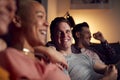 Group Of Gay Friends Sitting On Sofa At Home Watching Evening TV And Relaxing Together Royalty Free Stock Photo