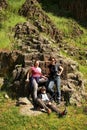 Group of geologists relaxing near volcanic rock