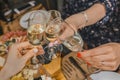 A group of girlfriends clinking glasses with a chilled drink, champagne, sparkling wine, close-up of the atmosphere of the holiday