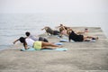 Group yoga exercises on the beach.