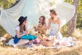 Group of girls friends making picnic outdoor. They have fun