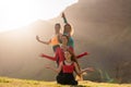 A group of girls meditate at sunset