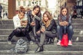 Group of girls sitting on the city stairs with smartphone Royalty Free Stock Photo