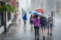 Group of girls walking at summer rain in the city