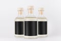 Group glass bottles for cosmetic, perfume, alcohol drink with black label, cork, yellow liquid on white background, mock up.