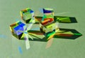 Group of glass dichroic cube refracts and reflects natural light into colorful spectrums.