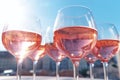 Group of glasses with pink rose wine. Scene emanates a luxurious yet minimalist ambiance. Clinking glasses with wine on the summer Royalty Free Stock Photo