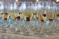 Group of glasses with sparkling white wine and raspberries on table Royalty Free Stock Photo