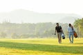 Group golf professional Golfer asian man walking in fairway with bag golf at golf  club. Royalty Free Stock Photo