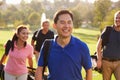 Group Of Golfers Walking Along Fairway Carrying Golf Bags Royalty Free Stock Photo