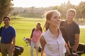 Group Of Golfers Walking Along Fairway Carrying Golf Bags Royalty Free Stock Photo