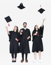 Group of grads throwing their hats in the air Royalty Free Stock Photo