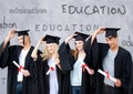 Group of graduates standing in front of education text