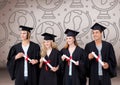 Group of graduates standing in front of world globe graphics