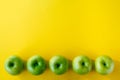 Group of green apples on yellow background Royalty Free Stock Photo