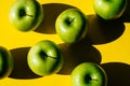 Group of green apples on yellow background Royalty Free Stock Photo