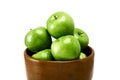 A group of Green Granny Smith cooking apples in a brown bowl isolated against a white background. Royalty Free Stock Photo