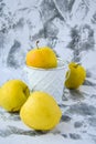 A group of green Granny Smith and golden apples in a white bucket against a white concrete background, copy space for text Royalty Free Stock Photo