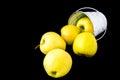 A group of green Granny Smith and golden apples in a white bucket against a dark brown background, copy space for text Royalty Free Stock Photo