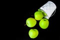 A group of green Granny Smith and golden apples in a white bucket against a dark brown background, copy space for text Royalty Free Stock Photo