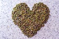 Group of green nuts with love shape on the table.