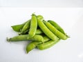 Group of green peas pods with stem isolated on white background Royalty Free Stock Photo