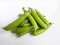 Group of green peas pods with stem isolated on white background Royalty Free Stock Photo