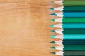 Group green pencil on wooden table