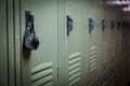 A row of green school lockers with a padlock