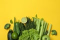 Group of green vegetables on yellow background Royalty Free Stock Photo