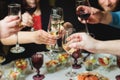Group of guests celebrate and raise glasses, toasting and cheering with alcohol glasses with wine and champagne in the restaurant Royalty Free Stock Photo