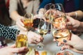 Group of guests celebrate and raise glasses, toasting and cheering with alcohol glasses with wine and champagne in the restaurant Royalty Free Stock Photo