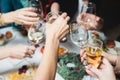 Group of guests celebrate and raise glasses, toasting and cheering with alcohol glasses with wine and champagne in the restaurant Royalty Free Stock Photo