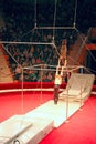 Group of gymnasts performing unimaginable tricks on horizontal bars in circus