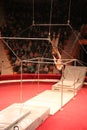 Group of gymnasts performing unimaginable tricks on horizontal bars in circus