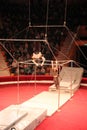 Group of gymnasts performing unimaginable tricks on horizontal bars in circus