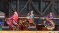 A group of gypsy dancers in long colorful skirts