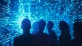 A group of hackers huddle around a glowing blue screen strategizing the best approach to hack into the boundaries of the