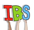 Group of Hands Holding IBS Letter