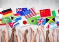 Group Of Hands Holding National Flags