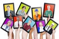 Group of Hands Holding Tablets with People's Faces Royalty Free Stock Photo