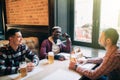 Group of handsome young men drink with their beers sitting at the pub relaxing together copyspace. people leisure lifestyle holida