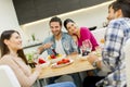 Young people sitting by the table