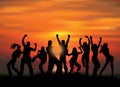 Group happy active people silhouettes and sunset. Royalty Free Stock Photo