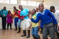 Group of happy African American people dancing together in a room