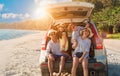 Group of happy Asian family fun travel on road trip in vacation at beach. Father, mother, daughter, son with enjoying on hatchback Royalty Free Stock Photo