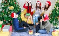 Group of happy Asian male female friends wear Santa Claus hat and reindeer antler headband together celebrating Christmas eve Royalty Free Stock Photo