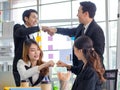 Group of happy Asian millennial professional successful male businessman and female businesswoman in formal suit sitting standing Royalty Free Stock Photo